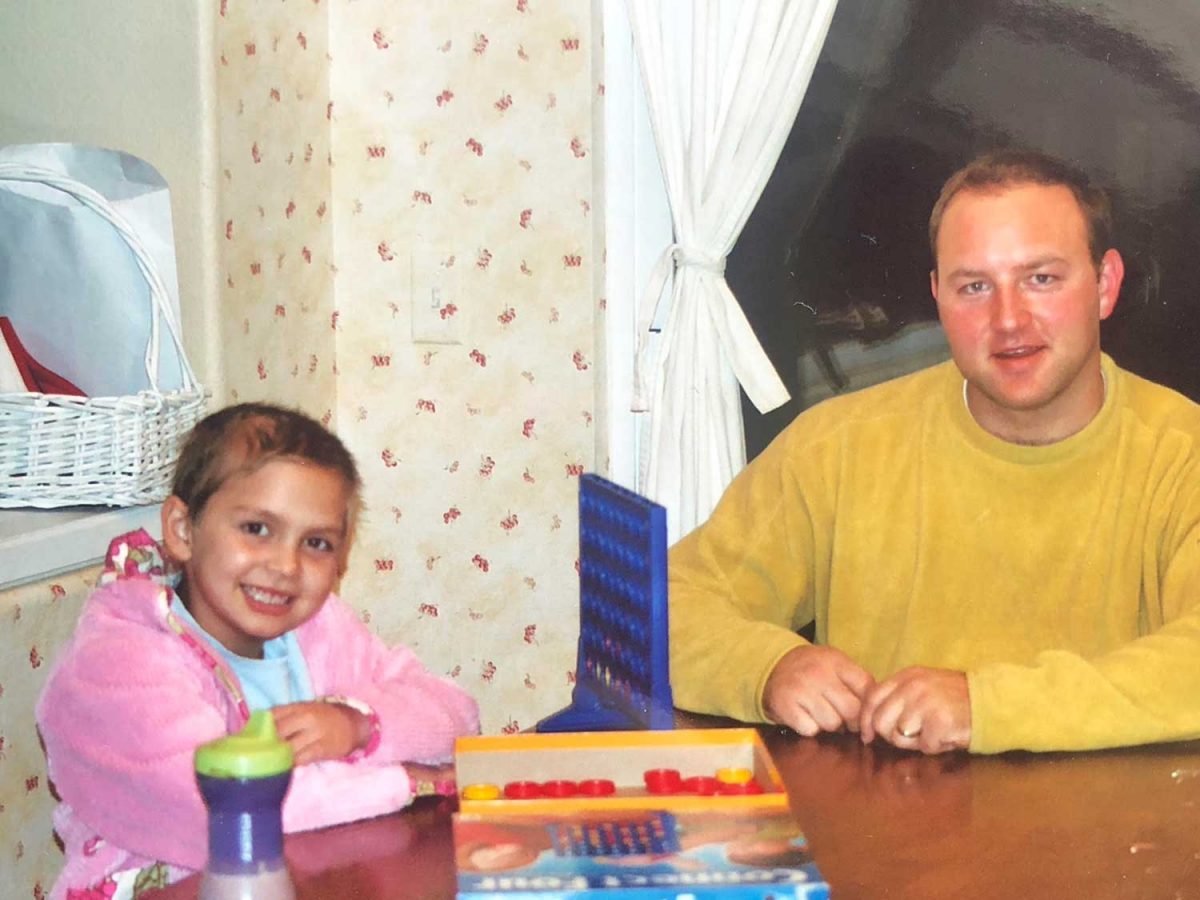 Gabby playing connect 4 with he uncle