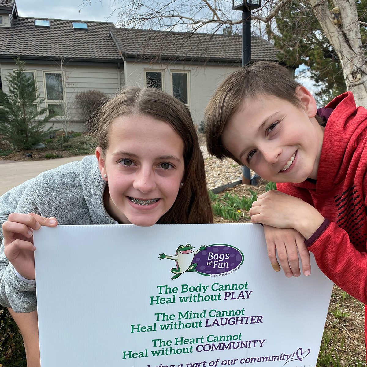 Kids with Bags of Fun Sign