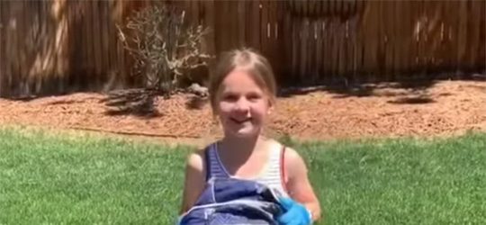 Video Screenshot - volunteer with bag in grass